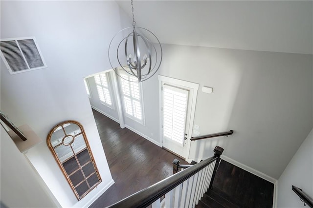 244 Rope Mill Rd, Woodstock, GA 30188 - staircase featuring wood finished floors, a chandelier, and baseboards