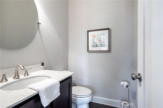 244 Rope Mill Rd, Woodstock, GA 30188 - half bathroom featuring vanity, toilet, and baseboards