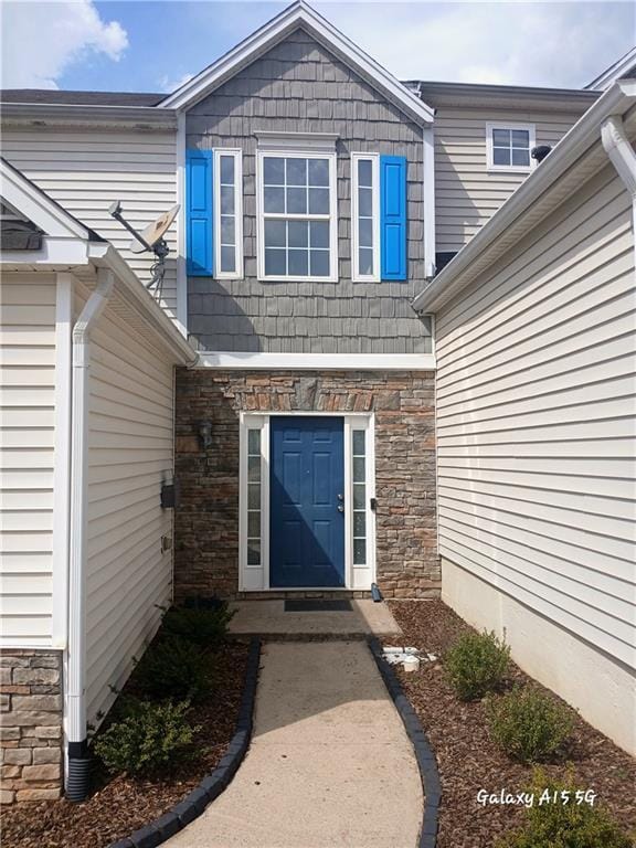 doorway to property featuring stone siding