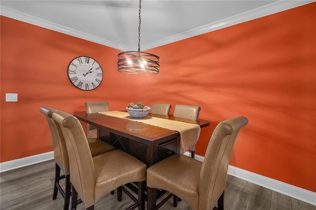 dining room with ornamental molding and dark wood-type flooring