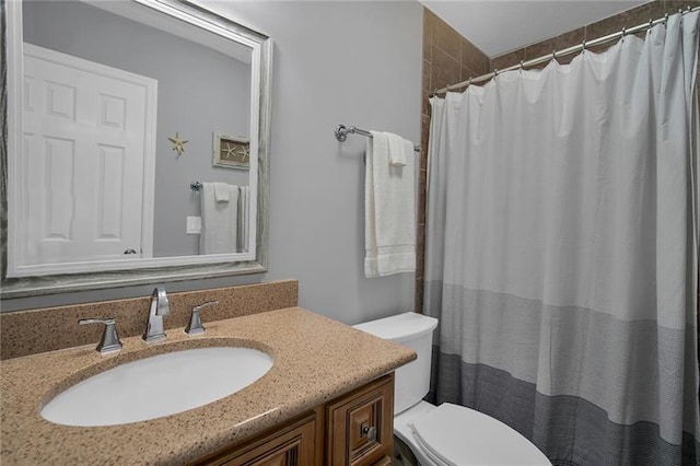 bathroom featuring vanity, toilet, and walk in shower