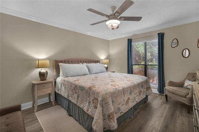 bedroom with ceiling fan, dark wood-type flooring, and ornamental molding