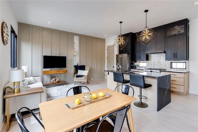 dining area featuring light wood-style flooring and recessed lighting