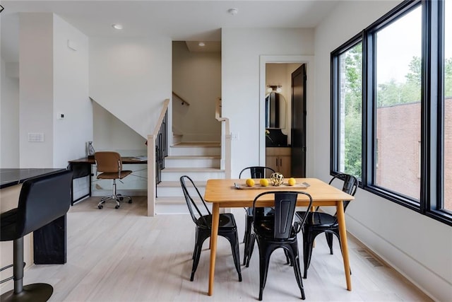 dining area featuring light wood-style flooring, stairs, recessed lighting, a desk, and baseboards