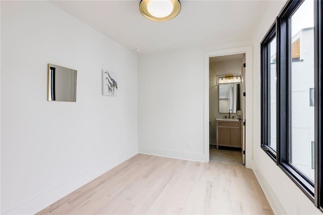 unfurnished room featuring light wood-style floors and baseboards