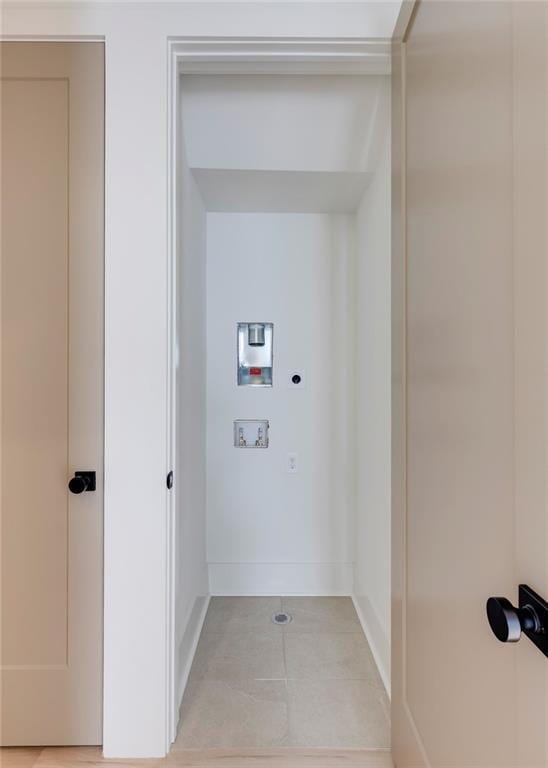 laundry room with hookup for an electric dryer, hookup for a washing machine, and light tile patterned floors