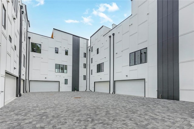 view of building exterior with a garage and driveway