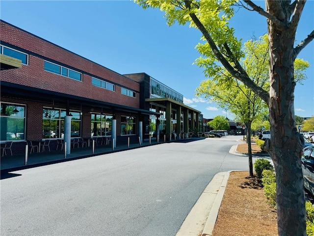 view of asphalt road featuring curbs