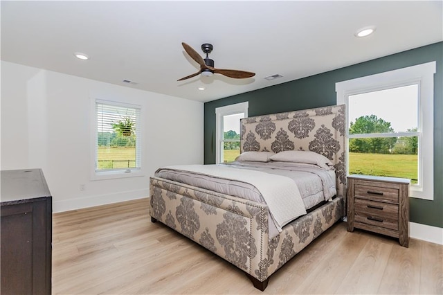 bedroom featuring light wood-type flooring and ceiling fan