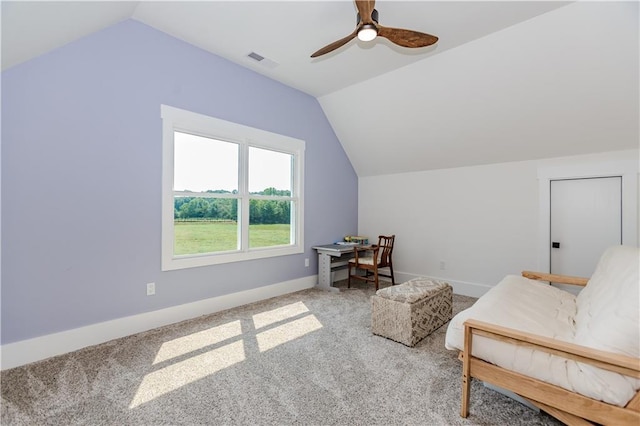 sitting room with ceiling fan, light colored carpet, and vaulted ceiling