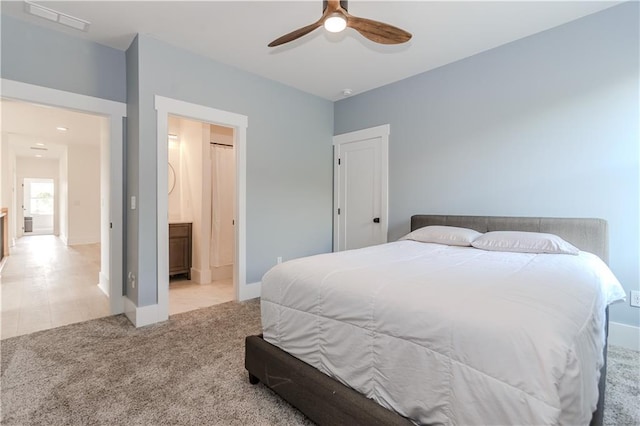 carpeted bedroom with connected bathroom and ceiling fan