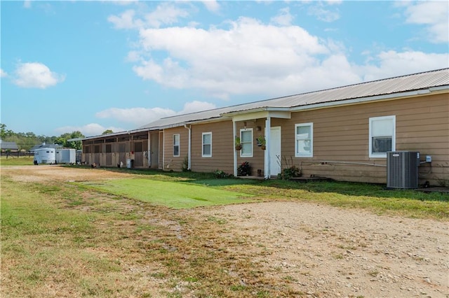 view of front of house featuring a front yard and cooling unit