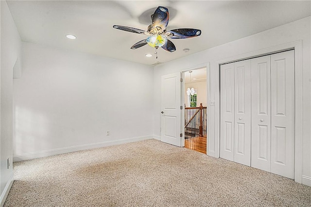 unfurnished bedroom featuring ceiling fan, a closet, and carpet