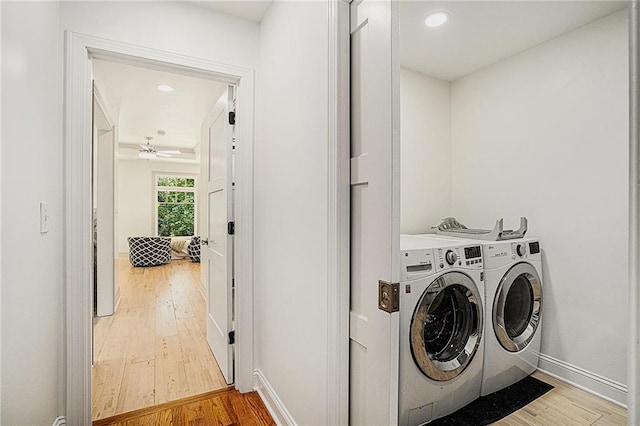 laundry area featuring ceiling fan, washer and clothes dryer, and wood-type flooring