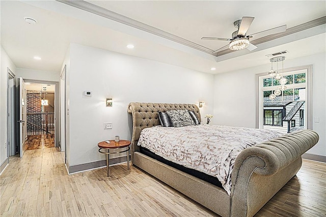 bedroom featuring ceiling fan, light hardwood / wood-style flooring, crown molding, and a raised ceiling