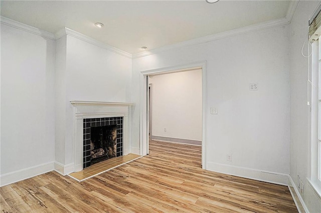 unfurnished living room with crown molding, light hardwood / wood-style floors, and a tiled fireplace