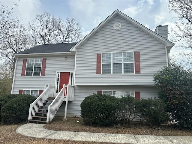 bi-level home featuring a chimney