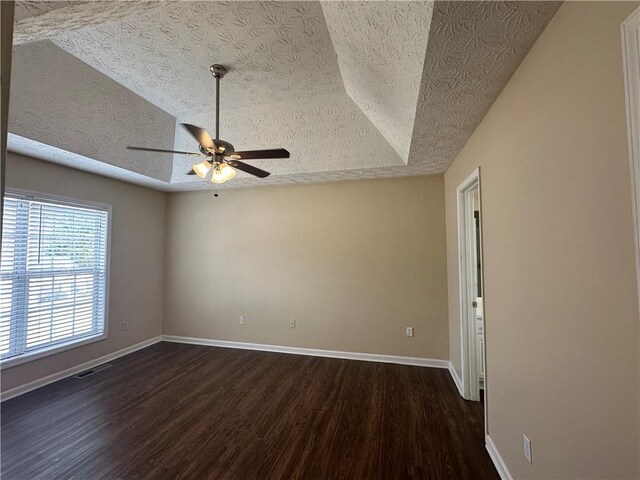 unfurnished room with a ceiling fan, a textured ceiling, baseboards, and wood finished floors