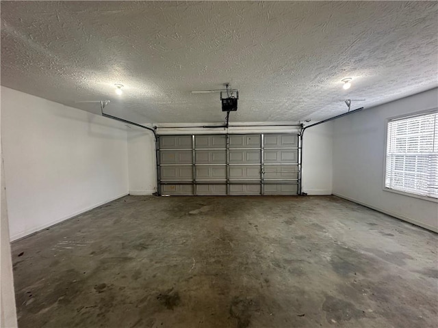 garage with a garage door opener and baseboards