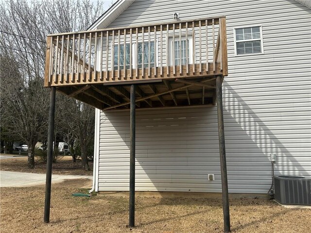 view of property exterior with a deck and central AC unit