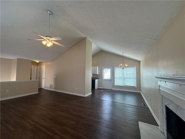 unfurnished living room with baseboards, visible vents, lofted ceiling, wood finished floors, and a fireplace