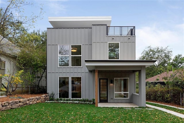 rear view of property featuring a yard