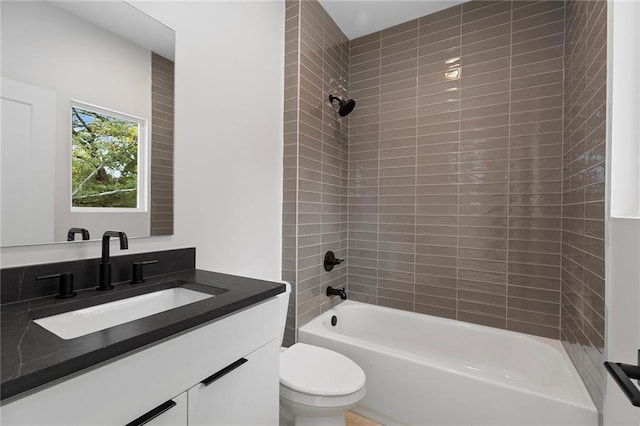 full bathroom featuring vanity, toilet, and tiled shower / bath