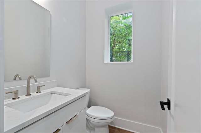 bathroom featuring hardwood / wood-style floors, vanity, and toilet