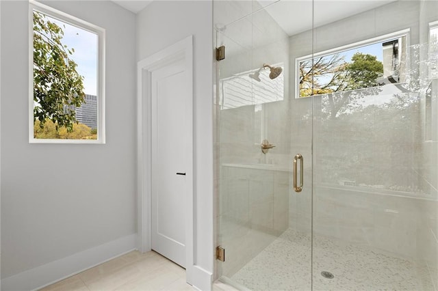 bathroom with tile patterned floors and walk in shower