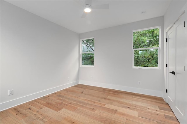 unfurnished room featuring ceiling fan, a healthy amount of sunlight, and light hardwood / wood-style flooring