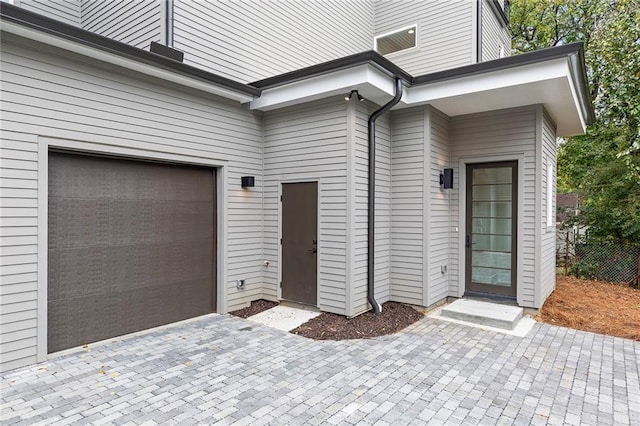 view of exterior entry with a garage