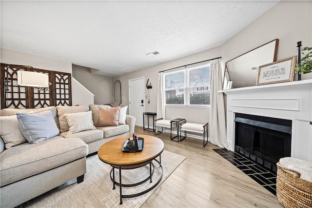 living room with hardwood / wood-style floors and a textured ceiling