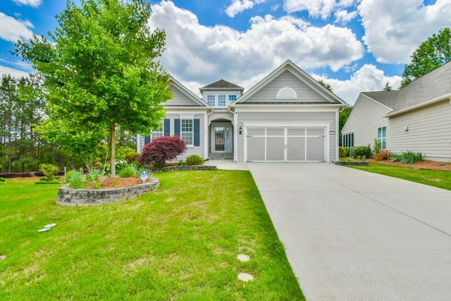 view of front of house featuring concrete driveway, a front yard, and a garage