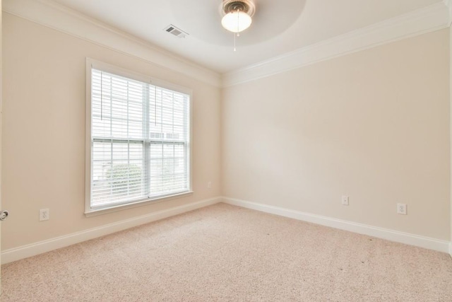 empty room with crown molding, a ceiling fan, carpet flooring, and baseboards