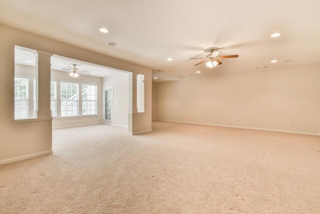unfurnished room with ceiling fan, decorative columns, recessed lighting, baseboards, and light carpet