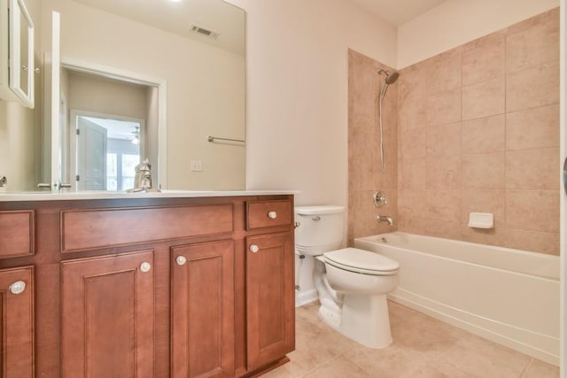 full bath with toilet, vanity, tile patterned flooring, and  shower combination