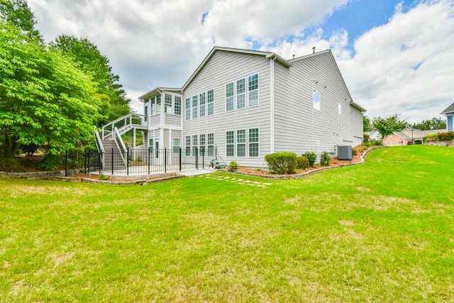 rear view of house with a patio, stairs, a lawn, and central air condition unit