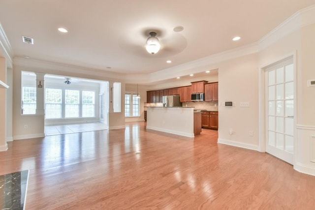 unfurnished living room with a ceiling fan, ornamental molding, light wood finished floors, baseboards, and recessed lighting