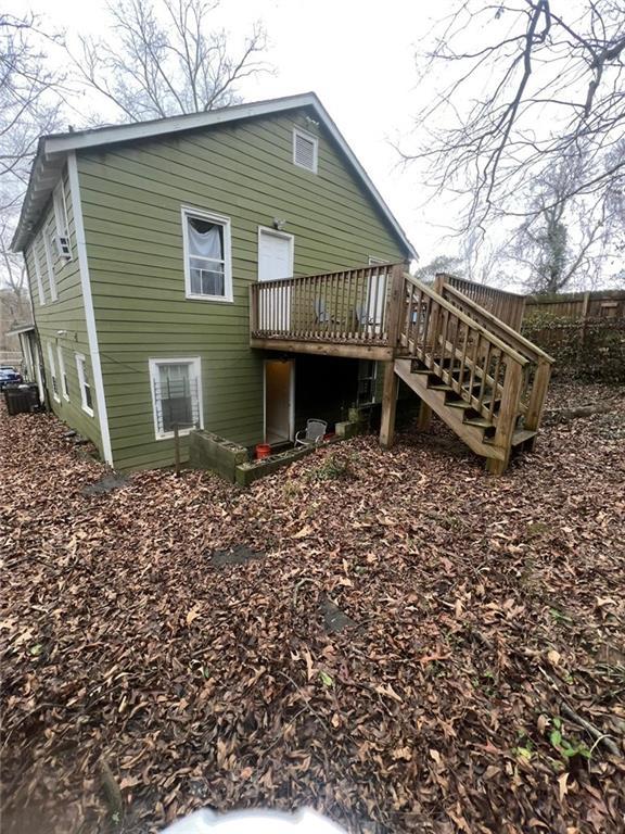 back of house with a wooden deck