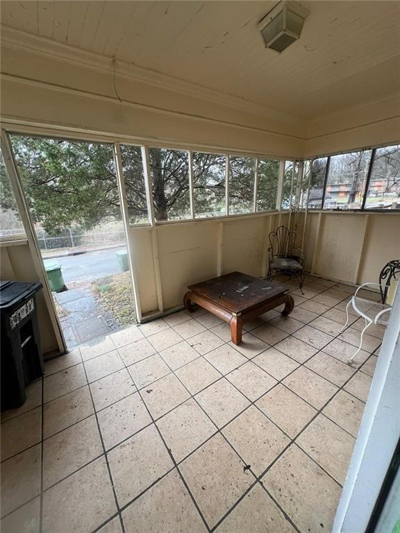 unfurnished sunroom featuring wooden ceiling