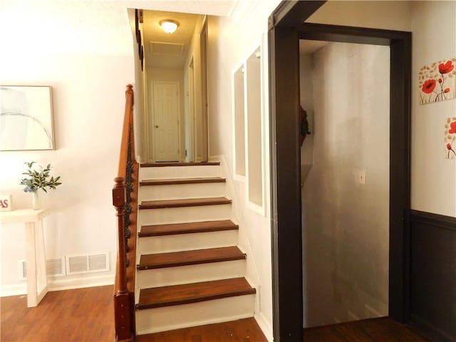 stairs with hardwood / wood-style floors