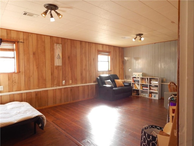 sitting room featuring dark hardwood / wood-style floors and wood walls