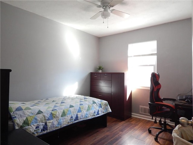 bedroom with ceiling fan and dark wood-type flooring