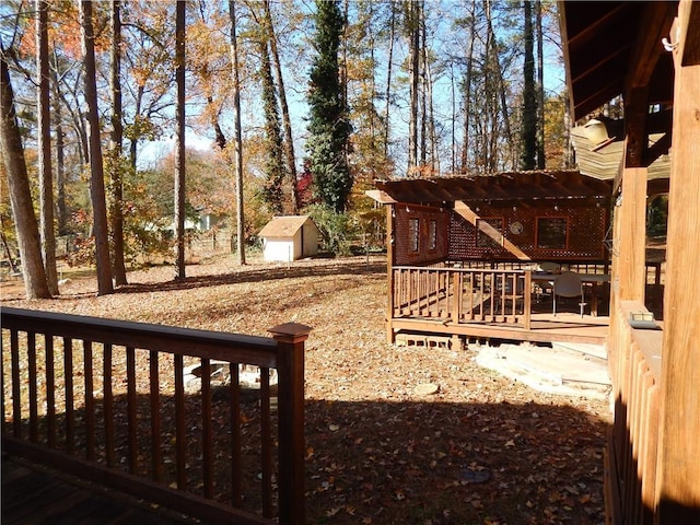 view of yard featuring a pergola, a shed, and a wooden deck