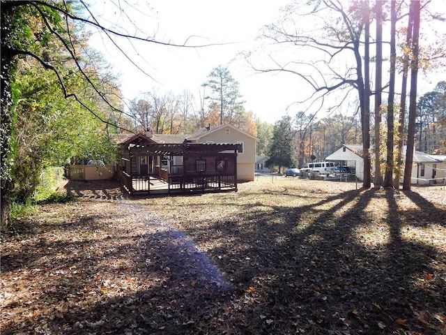 view of yard featuring a deck and a pergola