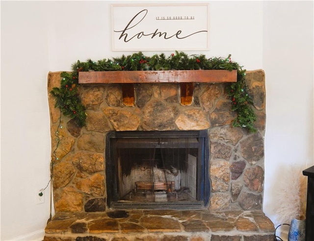 interior details featuring a stone fireplace