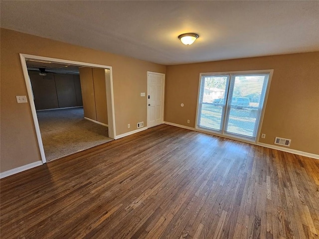 spare room with dark hardwood / wood-style flooring