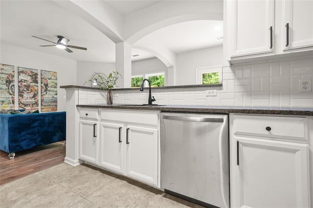 6571 Splitpine Ct, Atlanta, GA 30349 - kitchen with stainless steel dishwasher, a sink, a ceiling fan, and dark stone countertops