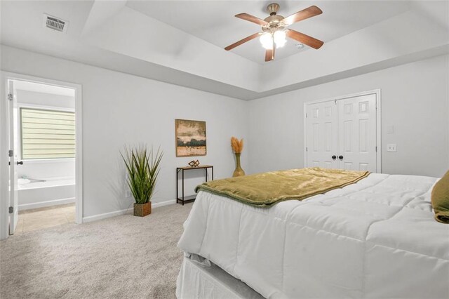 6571 Splitpine Ct, Atlanta, GA 30349 - bedroom with light carpet, baseboards, ensuite bath, a closet, and a raised ceiling