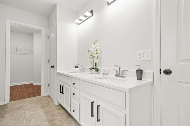 6571 Splitpine Ct, Atlanta, GA 30349 - bathroom featuring double vanity and a walk in closet